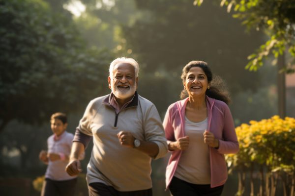 Indian happy senior couple jogging or taking a walk in the park